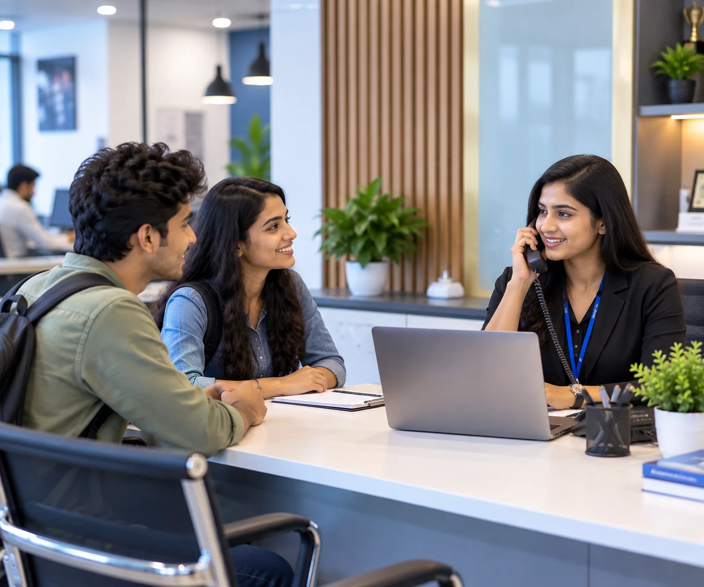 Students speaking with the E-World Academy team at the front desk